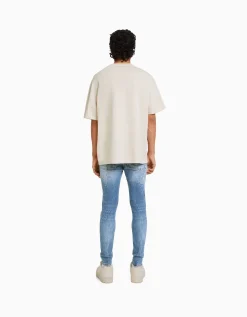 BERSHKA Jean skinny déchirures taches de peinture Bleu lavé Flash Sale